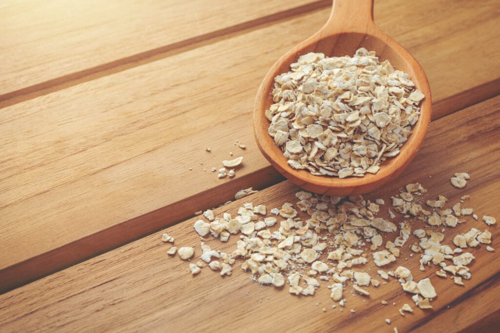 Oatmeal is placed on a brown wood background.